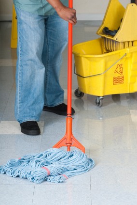 Superior Janitorial Service, LLC janitor in Madison, NC mopping floor.